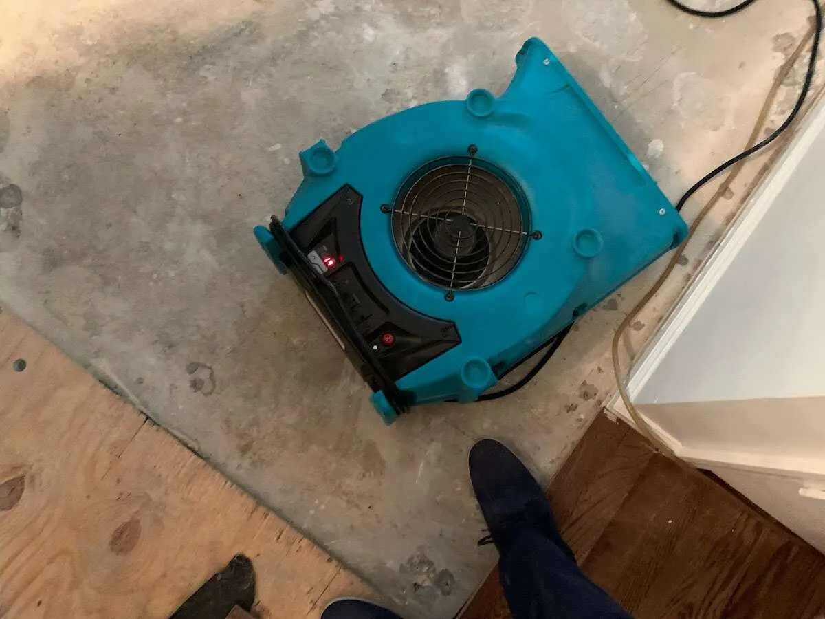 Air mover drying subfloor during Commercial Water Damage Restoration in Colts Neck